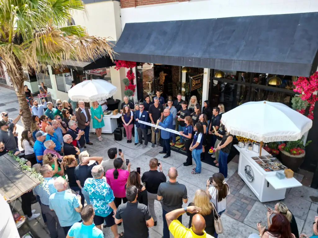 Aerial view of the crowd gathered for the Brije Custom Homes grand opening ribbon-cutting ceremony in downtown Ocala, Florida